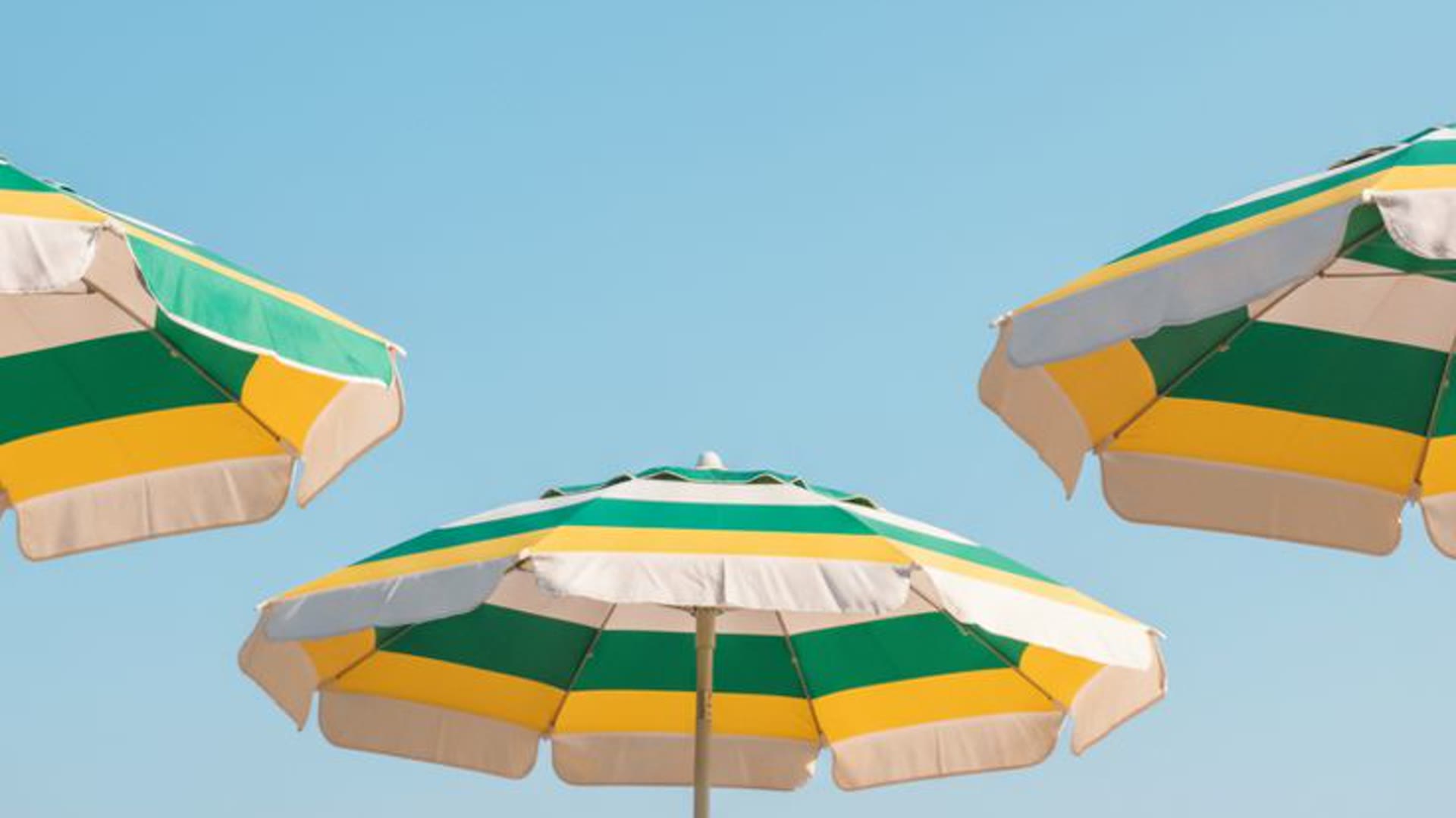 Umbrellas under a blue sky