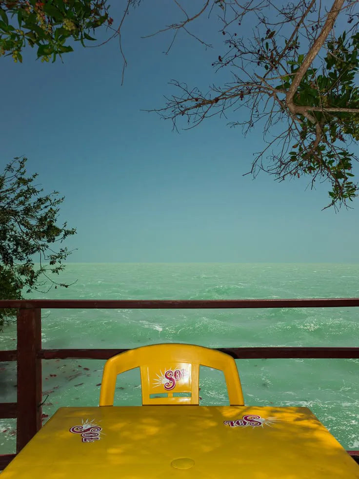 A yellow table overlooking the ocean