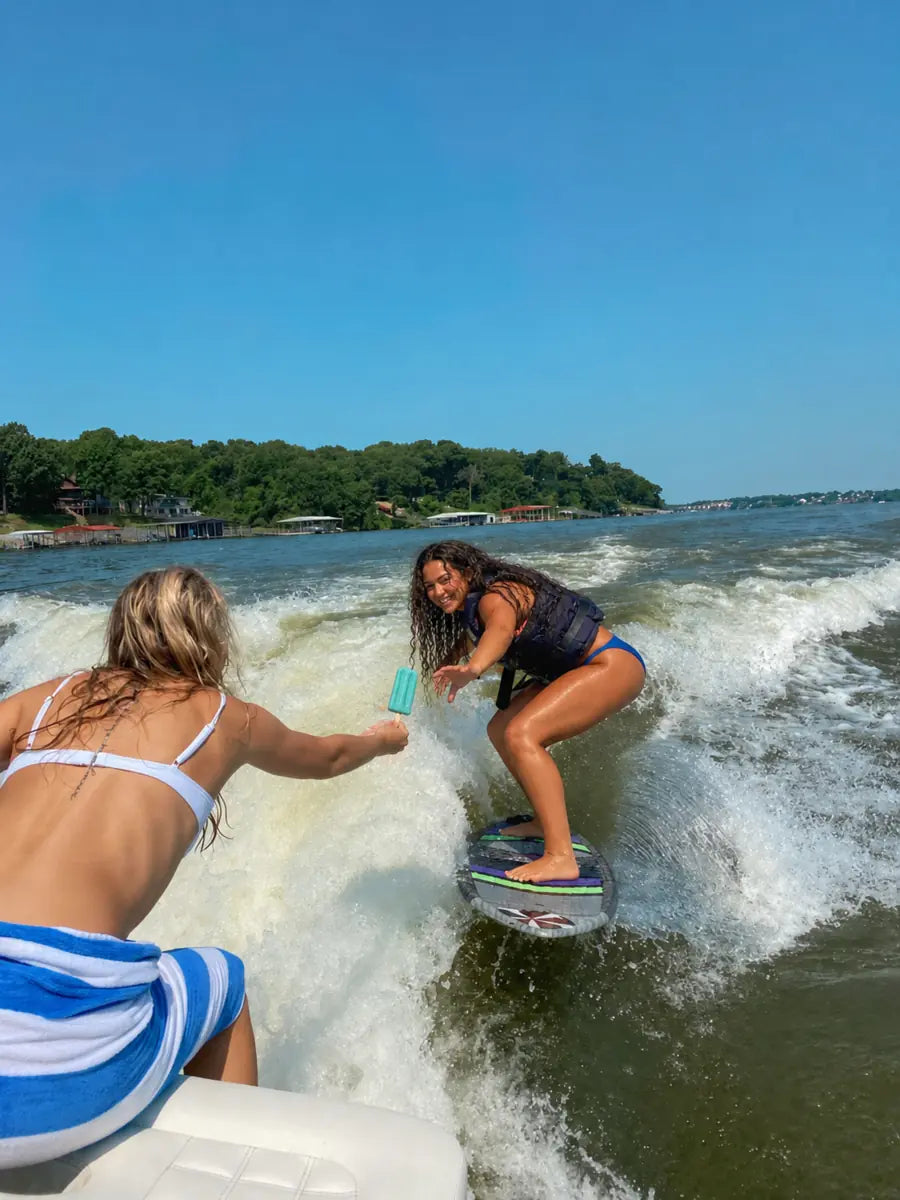 Friends sharing a frozen pop while wakesurfing