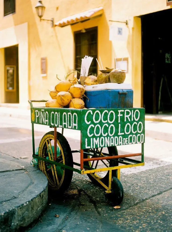 A street cart selling cold coconuts