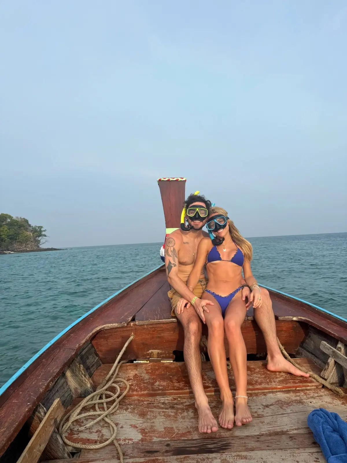 Elyse and Gabriel wearing snorkel masks on a boat